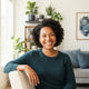 A smiling, diverse pet owner in a bright, modern home interior reflecting a happy and satisfied customer experience.