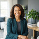 A diverse woman smiling in a bright, modern living space with slate blue and charcoal decor.
